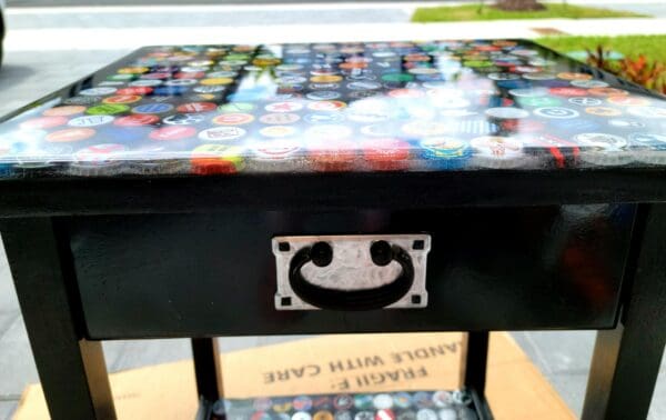 A table with a drawer and some buttons on it