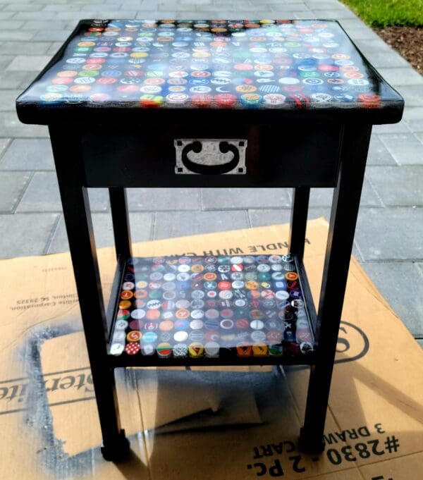 A table with a drawer and two shelves on top of it.