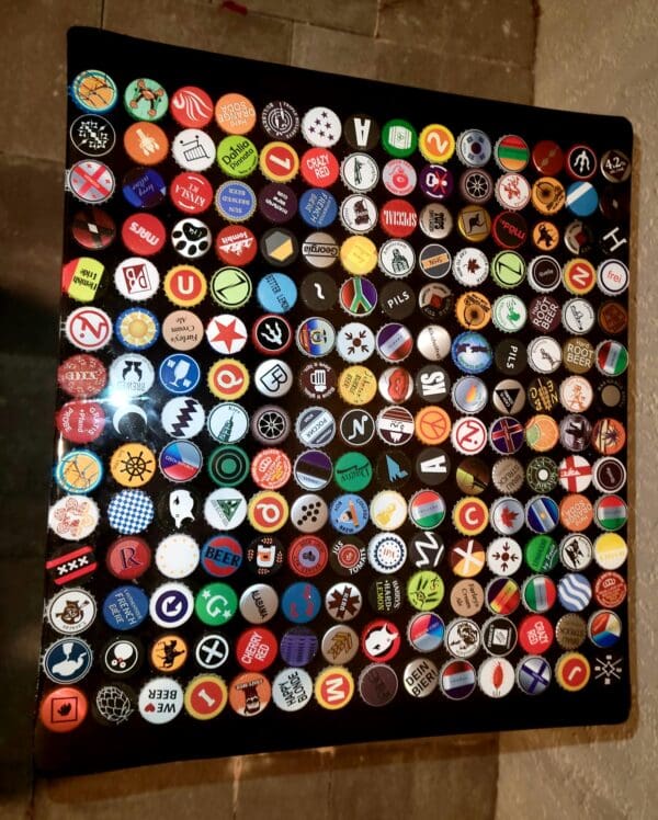 A table covered in many different types of bottle caps.