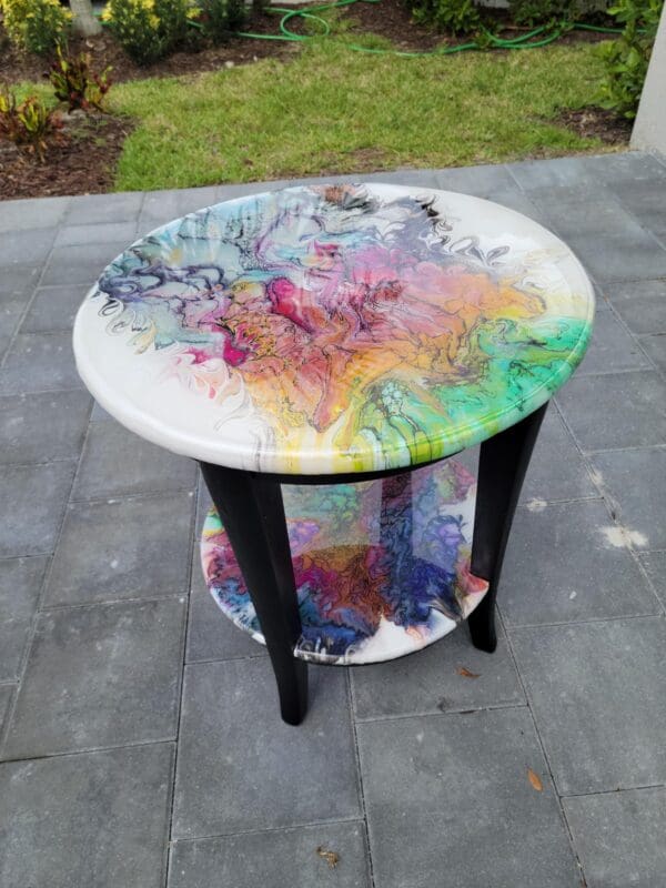 A table with paint on it sitting outside.