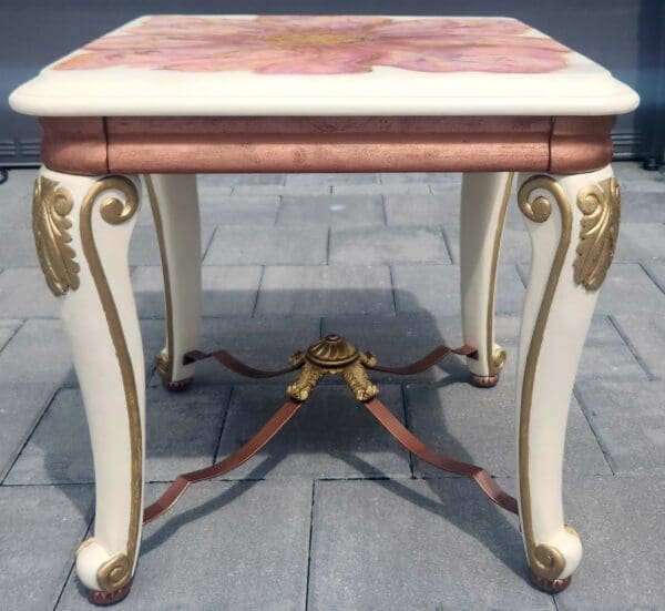 A table with gold and pink paint on it.