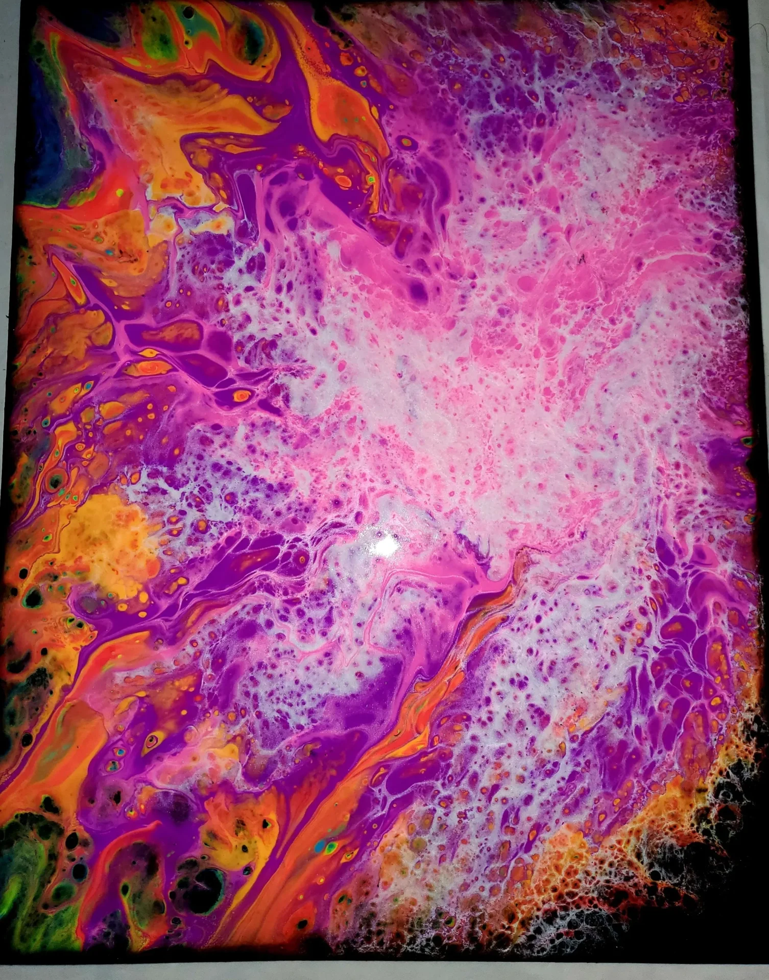 A painting of purple and orange swirls on the ground.