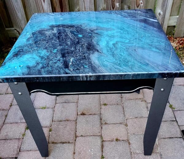 A table with blue and black marble on top.