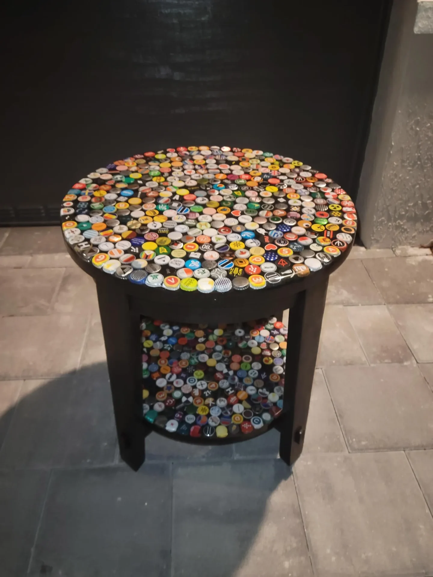 A table with many different colored bottle caps on it.