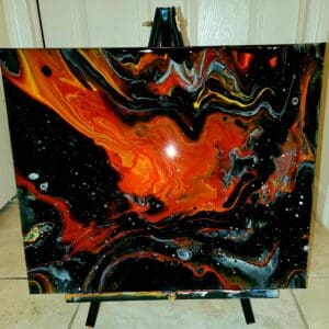 A painting of fire and black paint on the floor