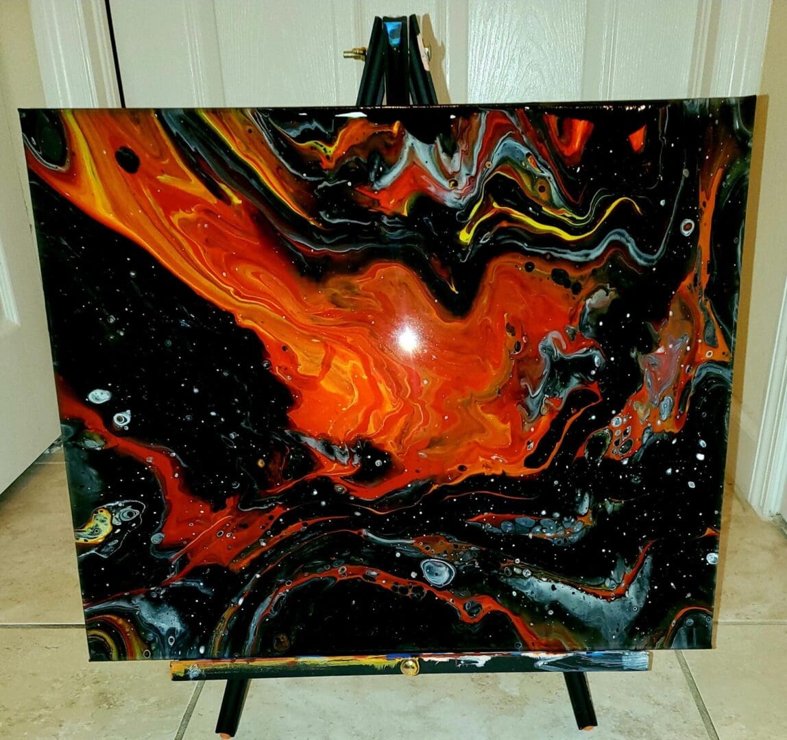 A painting of fire and black paint on the floor