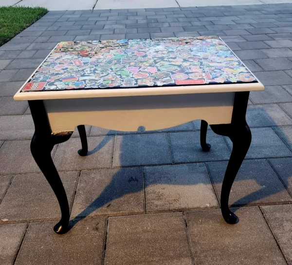 A table with a mosaic top on the ground.