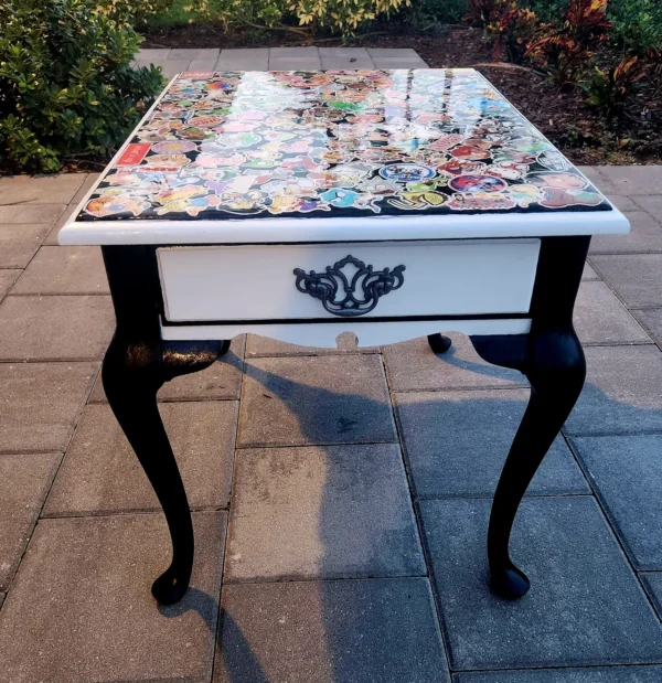 A table with a glass top and black legs.