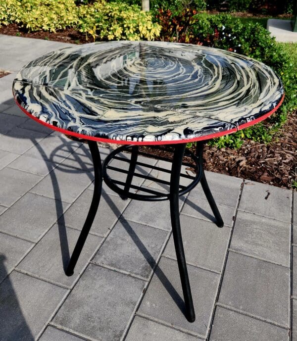 A table with a black and red rim on top of it.