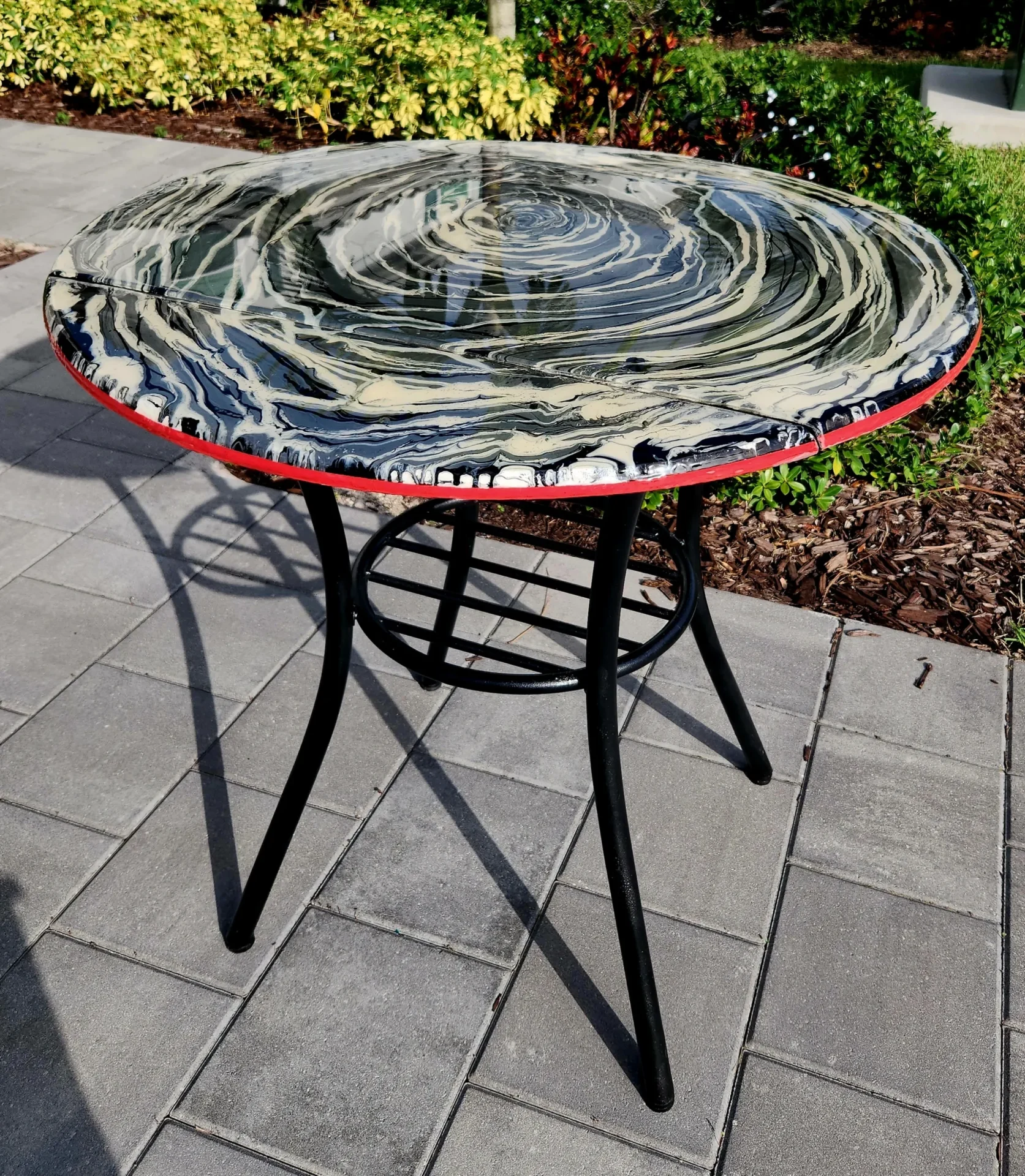 A table with a black and red frame on top of it.