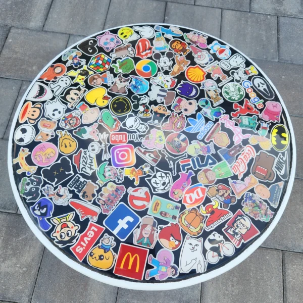 A round table covered in many different stickers.