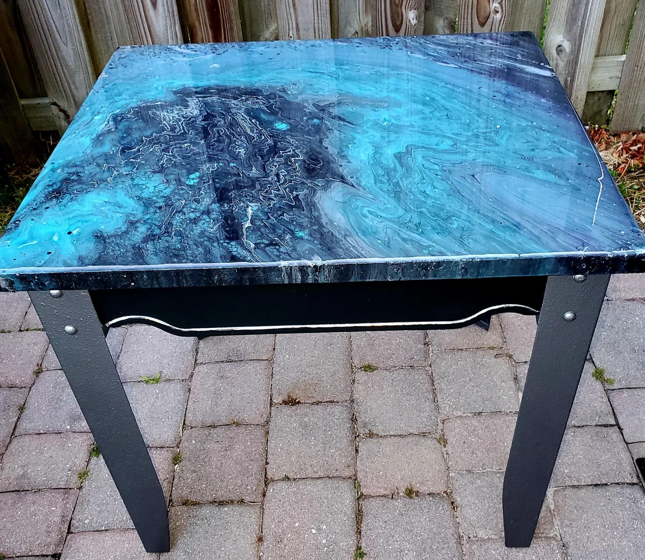 A table with blue and black marble on top.