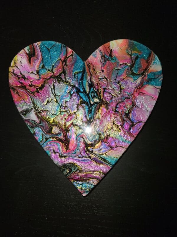 A heart shaped piece of art with colorful paint.