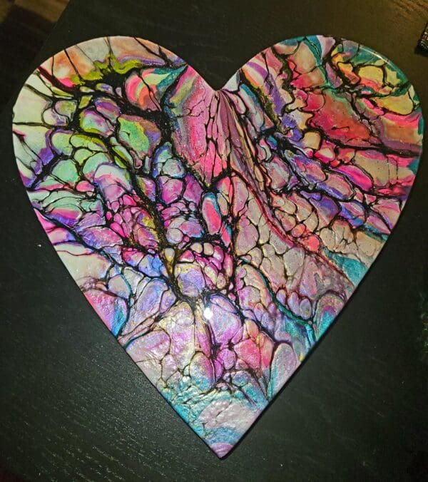 A heart shaped piece of art with colorful paint.