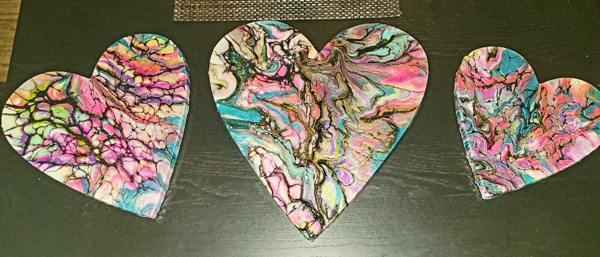 A heart shaped coaster with colorful designs on it.